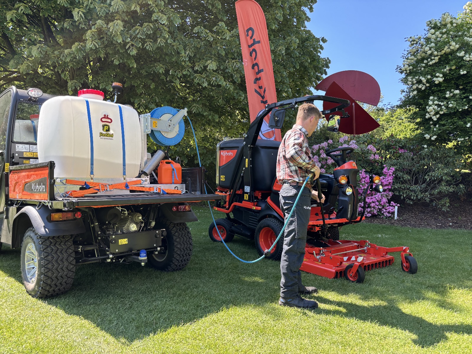Foresteel PW-300 Mobile pressure washer shown inside Kubota RTV cargo box, and demoed washing mowing equipment