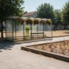 Summer park maintenance scene showing bus shelter grime and drought-stressed flower beds for cleaning and watering schedule